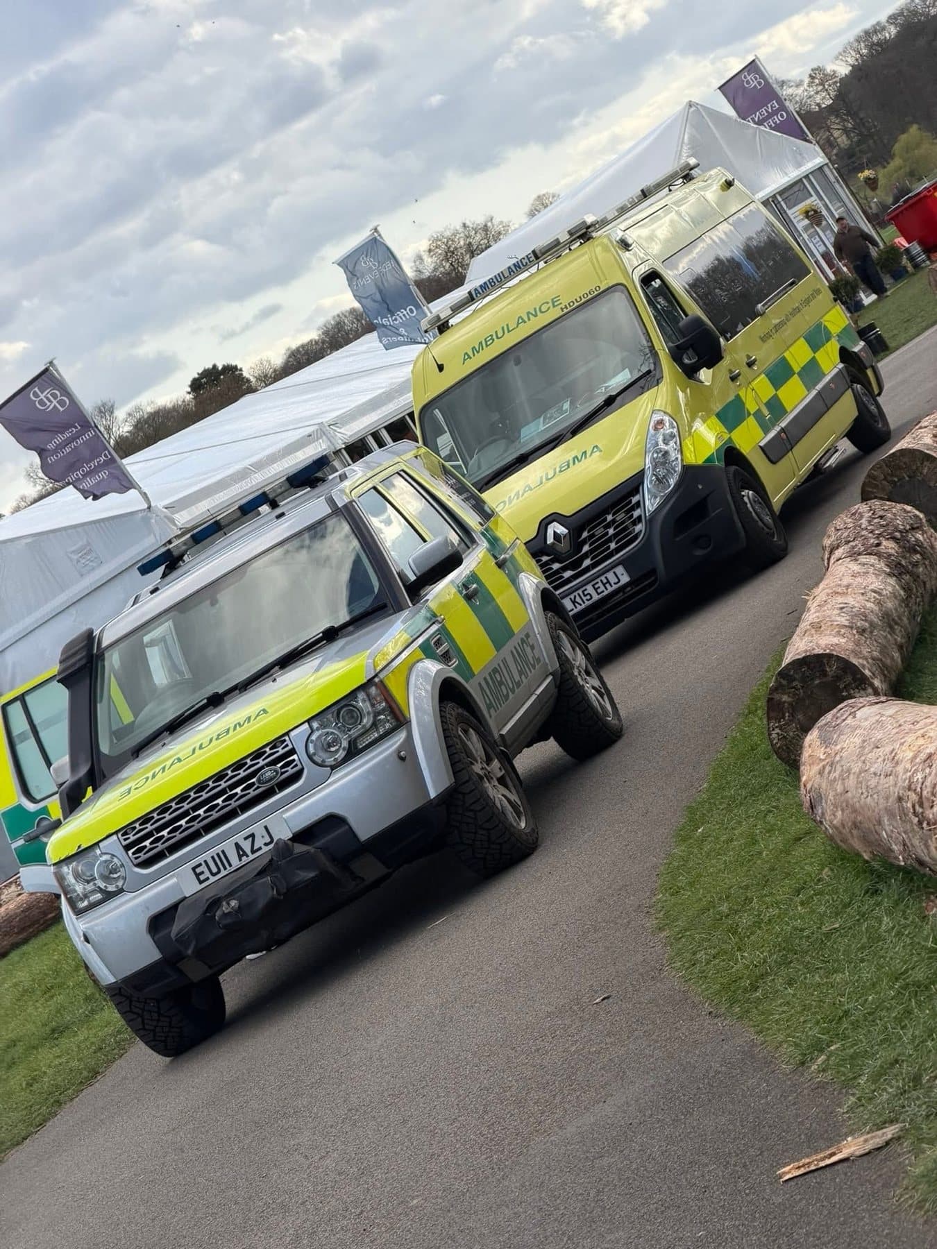 AAA.AMBULANCE3 response vehicle and ambulance parked beside event marquees
